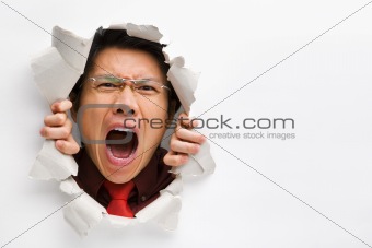 Man screaming from the hole in wall with copy space