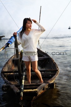 Lady looking at sunrise on traditional boat