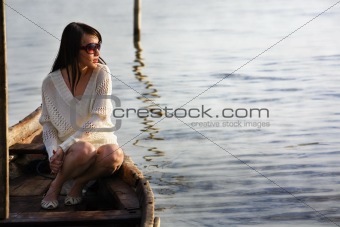 Lonely lady on boat looking sunrise