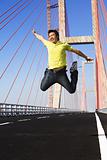 Young man jump very high in bridge area