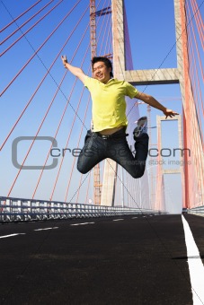 Young man jump very high in bridge area