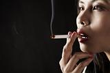 Woman smoking on dark area