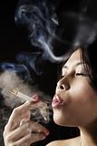 Female inhale smoke from cigarette