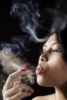 Female inhale smoke from cigarette