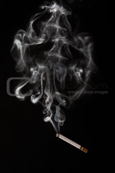 Burning cigarette falling of with smoke having abstract shape
