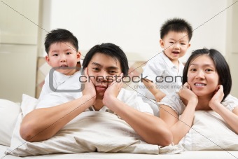Asian family on bed