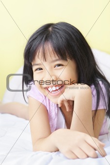Happy young girl in bedroom
