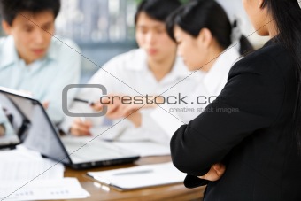 Female boss watching her employees working