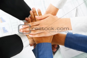 Leader and his employees hands in unity