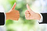 Thumbs up over green background
