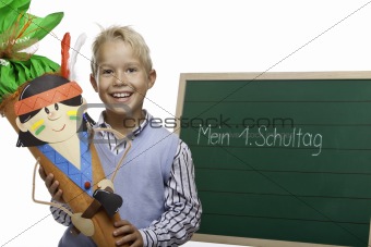 Child beside chalkboard having first schoolday