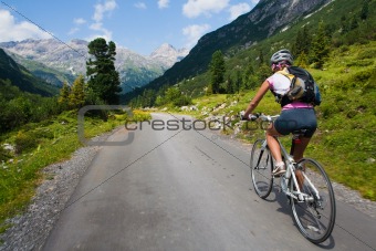 Girl riding fast on bicycle. Motion blur