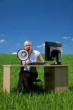 Business Concept Woman Using Megaphone In A Green Field