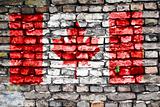 Flag of Canada painted on an old brick wall