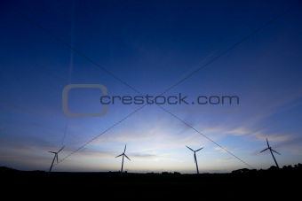 Abstract wind turbines at night. 
