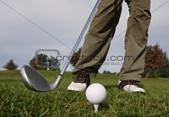 Hitting the ball with a club.