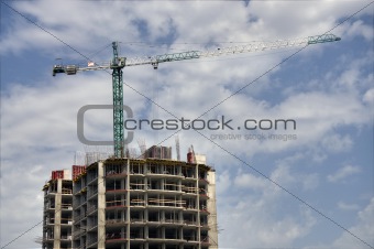 steel crane above incomplete building