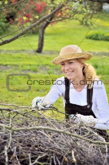 Young woman cleaning tree limbs