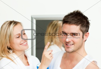 Happy man with cream in his nose with her girlfriend