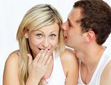 Man whispering a woman a secret