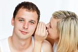 woman whispering a man something important