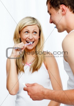 Couple having fun cleaning their teeth