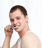 Attractive man cleaning teeth