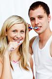Couple cleaning their teeth