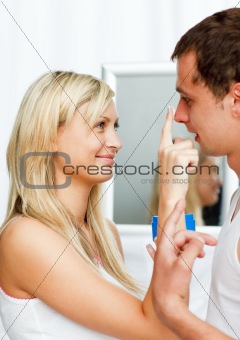 Beautiful woman putting cream on her boyfriend's nose
