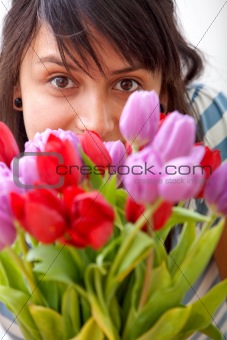 Young girl smelling flowers