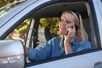 Attractive Blonde Woman Using Cell Phone While Driving.