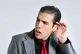 Businessman with hand in ear as a deafness sign