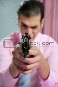 Businessman point his handgun to camera