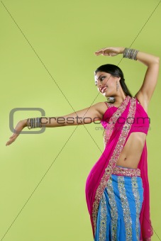 Beautiful indian young brunette woman dancing