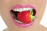 Delicious strawberry fruit in woman mouth