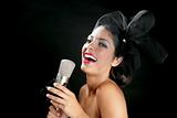 Beautiful woman singing on a vintage microphone