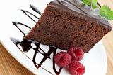 Slice of delicious chocolate cake with fresh raspberries