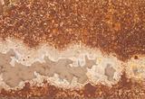 Rusty iron with peeled paint and corrosion stains background