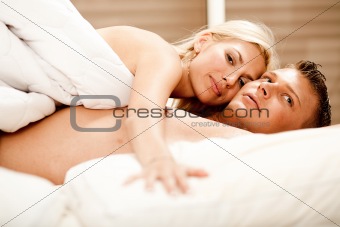 Lovers relaxing in bed