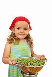 Little girl with lots of peas