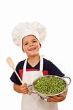 Happy chef with lots of fresh green peas