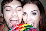 Couple Biting into Lollipop