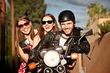 Trio posing on motorcycle
