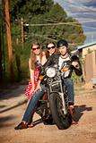 Trio posing on motorcycle