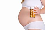Presenting glass of apple juice in front of pregnant belly
