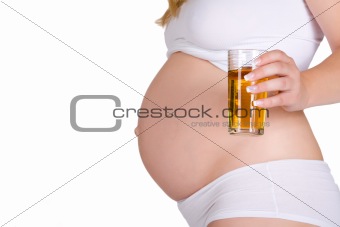 Presenting glass of apple juice in front of pregnant belly