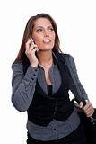 A young businesswoman in a dress is making a phone call
