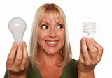 Woman Holds Energy Saving and Regular Light Bulbs Isolated on a White Background.
