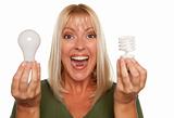 Woman Holds Energy Saving and Regular Light Bulbs Isolated on a White Background.