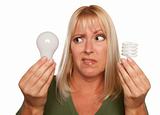 Funny Faced Woman Holds Energy Saving and Regular Light Bulbs Isolated on a White Background.